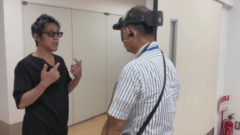 中村さん職員の前に立つ画像